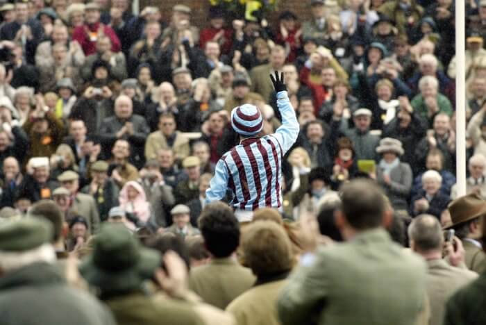 Jim Culloty salutes an adoring crowd from atop Best Mate, after their third Gold Cup win, in 2004.